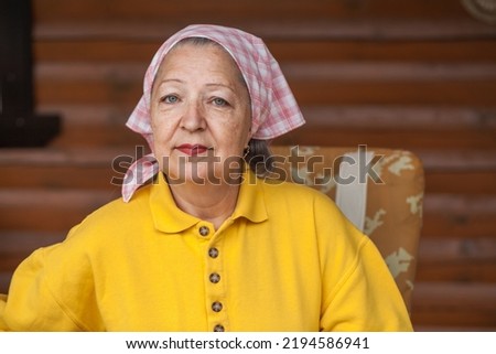 Portrait of an elderly woman with a scarf on her head