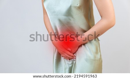 Menstrual pain, woman with stomachache suffering from pms , endometriosis, cystitis and other diseases of the urinary system, painful area highlighted in red