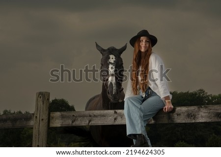 Young girl poses with her horse  in western style
