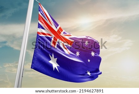 Australia national flag waving in beautiful clouds. Royalty-Free Stock Photo #2194627891