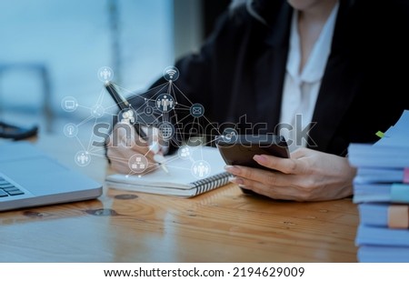 Businesswoman hands working on smartphone and laptop computer with digital finance marketing chart and future technology innovation and digital transformation concept.