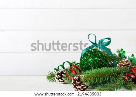 New Year Christmas tree toy, branches of a christmas tree, New Year decorations on a colored background.