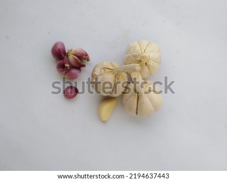 Natural fresh shallot and garlic. In Indonesia called bawang merah dan bawang putih. This is usually for seasoning, isolated on white background