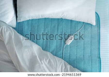 Bed with electric heating pad, top view Royalty-Free Stock Photo #2194651369