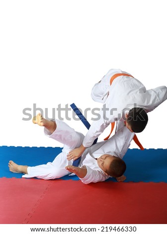 Judo throw in execution athlete with an orange belt Royalty-Free Stock Photo #219466330