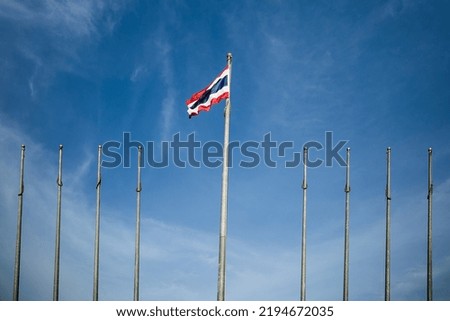 Lonely Thailand national flag flying on flagpoles with blue sky background.