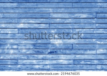 Wall of vintage boards covered with faded paint. Decorative wooden background shabby chic.