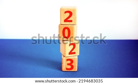 2023 happy new year symbol. Wooden cubes symbolize the change from 2022 to the new year 2023. Beautiful white and blue background. Copy space. Business and 2023 happy new year concept.