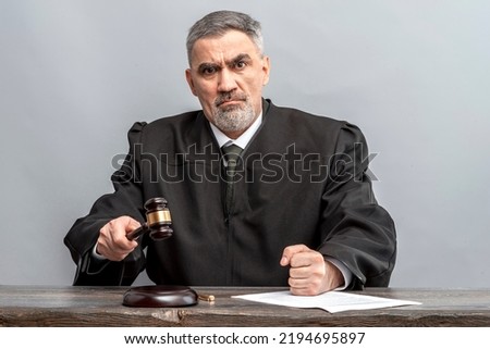 Judge banging judge's gavel. Law Lord wearing gown using a hammer for attention and verdict, justice judgment at courts of law. Royalty-Free Stock Photo #2194695897