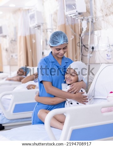Little girl patient embracing female nurse at hospital
