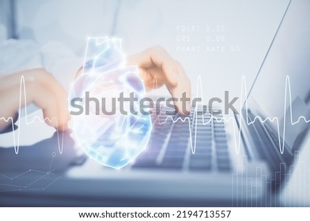 Heart drawing with man working on computer on background. Medical concept. Double exposure.