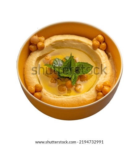 Hummus. Large bowl of homemade hummus garnished with chickpeas, red sweet pepper, parsley and olive oil, flat lay, middle east food - isolated 