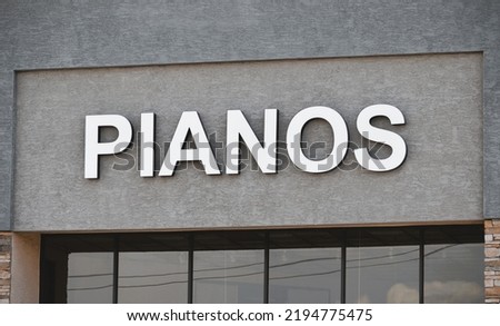 Piano store sign letters on music business building entrance