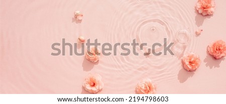 Pink aquatic, transparent water texture with ripples and drops and pink flowers Royalty-Free Stock Photo #2194798603