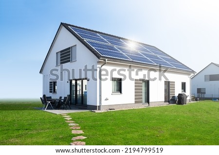 House New Solar Roof. Sustainable Future Investment Royalty-Free Stock Photo #2194799519