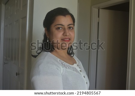 Headshot portrait of confident young Indian woman image. Profile picture of millennial mixed race female look at camera. Diversity concept.
