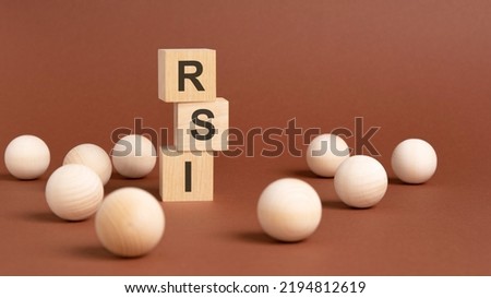 pyramid of wooden cubes with the abbreviation rsi, wooden balls on a brown background