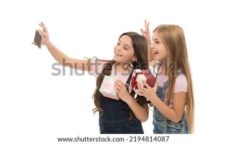 A private selfie shooting. Adorable little girls taking birthday selfie. Pretty small children making photograph with selfie camera on smartphone. Selfie is now a part of modern life