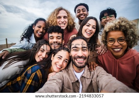 Multiracial young group of happy people taking selfie portrait - Millennial diverse friends laughing and having fun together Royalty-Free Stock Photo #2194833057