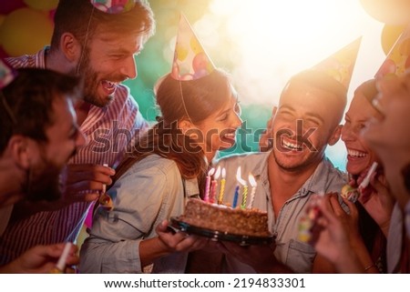 Group of friends celebrating birthday together outdoors. Concept of celebrating and happiness.