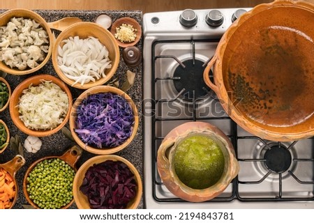 Clay pot on a stove ready to cook Fiambre a traditional dish for All Saints' Day. Royalty-Free Stock Photo #2194843781
