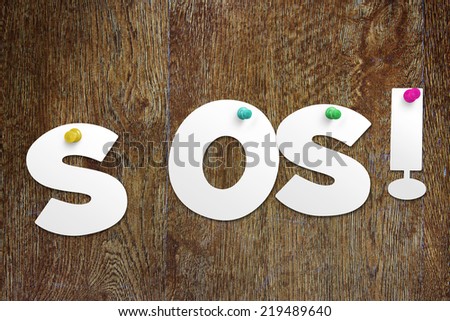 Word SOS cut out of paper