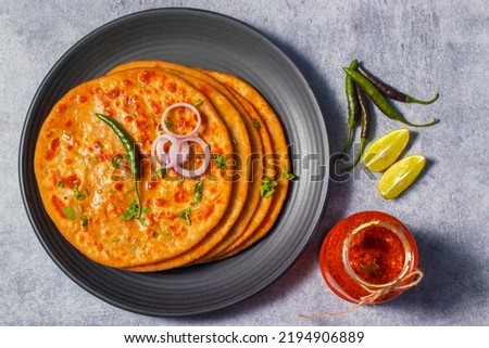 North Indian famous food Aloo Paratha with mango pickle and butter. Royalty-Free Stock Photo #2194906889