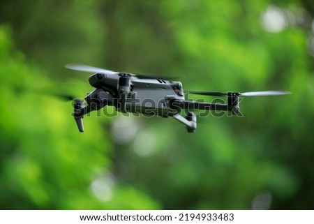 Flying drone in summer forest
