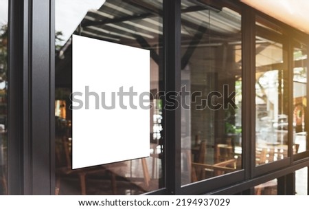 White paper poster mockup displayed outside the building restaurant. Marketing and business concept.  Royalty-Free Stock Photo #2194937029