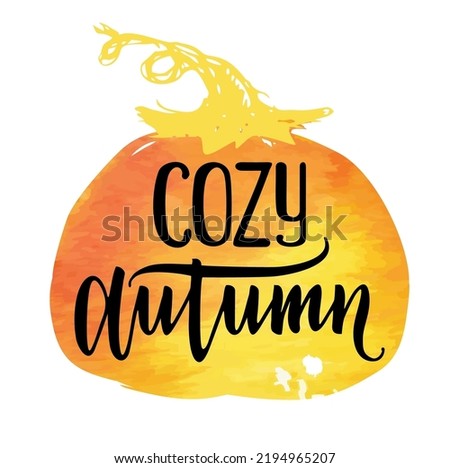 Cozy autumn. Fall quote vector illustration isolated on background of a pumpkin watercolor stain. Vector ink lettering. Modern calligraphy style.
