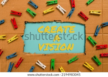 Conceptual caption Create A Vision. Conceptual photo Develop a strategy mission motivation purpose to achieve Important Ideas Written Under Ripped Cardboard With Colored Pegs Around.