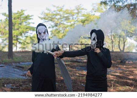Children in costume for Halloween outdoors during the day