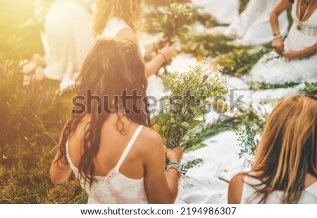View of women making wreaths with beautiful flowers