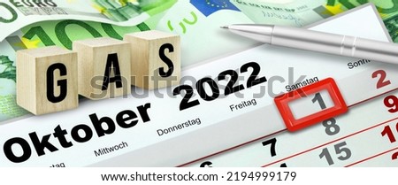 German calendar 2022 Oktober 1 and symbolic Gas on wooden cubes with 300 Euro banknotes Royalty-Free Stock Photo #2194999179