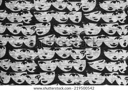 Black and white human face fabric background.