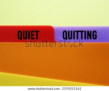 Office folder with text on tag QUIET QUITTING, when employees not engaged or taking job seriously, do minimum required but focus on job outside office Royalty-Free Stock Photo #2195015161
