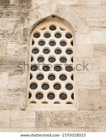 New muslim arched window with round glasses closeup
