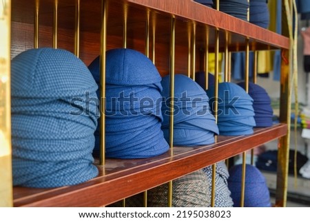 A photograph of Jewish blue kippahs in Israel inside a brown shelf
 Royalty-Free Stock Photo #2195038023
