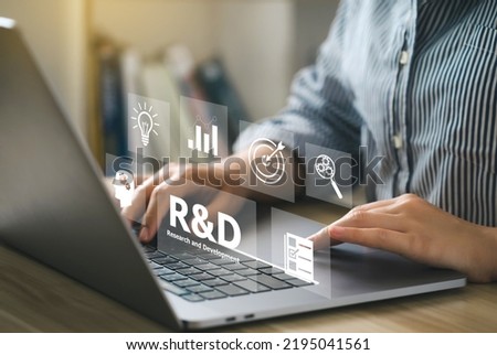 Women use a computer with the R and D icon for Research and Development on the laptop screen. RD Research and Development Business Science Technology Concept. Manage costs more efficiently.  Royalty-Free Stock Photo #2195041561