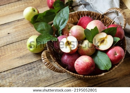 Organic fruits. Fall harvest background. Farmer's market. Basket of ripe apples on a rustic wooden table. Copy space.