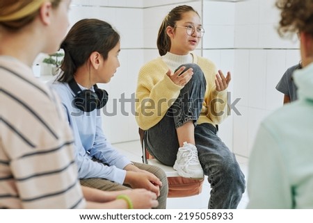 Portrait of teenage girl sharing feelings in support group circle for children Royalty-Free Stock Photo #2195058933