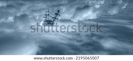 Sailing old ship flying over the clouds Royalty-Free Stock Photo #2195065007