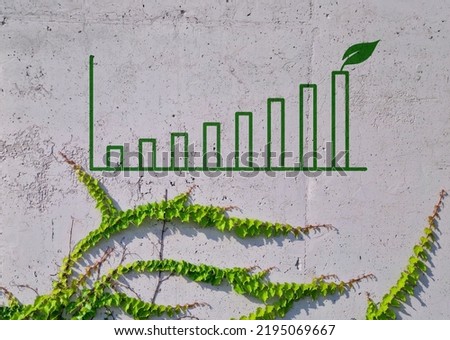 Business chart on a concrete wall and leaves. Impact Investing concept. Royalty-Free Stock Photo #2195069667