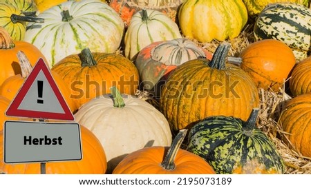 Sign Autumn german "Herbst" in Front of Pumpkins