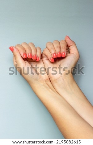 Manicure on women's hands. The red color of the varnish