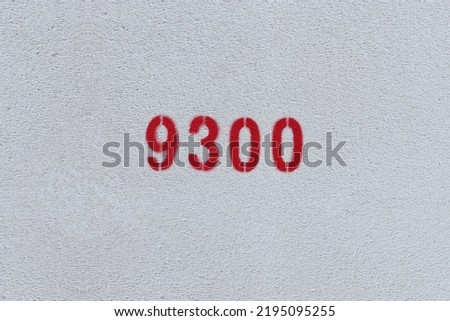 Red Number 9300 on the white wall. Spray paint.
