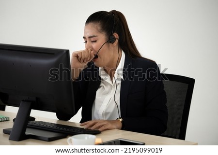 Young Asian business woman  yawning at work.