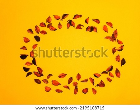 potpourri ellipse frame on yellow autumn background Royalty-Free Stock Photo #2195108715