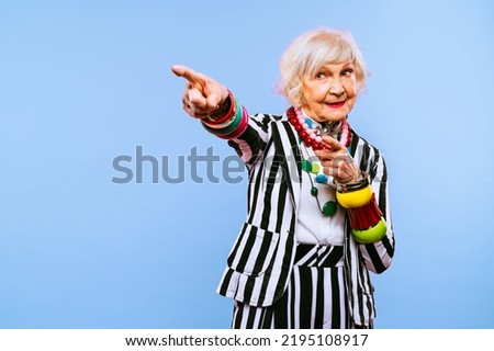 Happy and funny cool old lady with fashionable clothes portrait on colored background - Youthful grandmother with extravagant style, concepts about lifestyle, seniority and elderly people Royalty-Free Stock Photo #2195108917