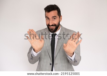 Bearded man making stopping gesture. Male model in suit refusing something. Portrait, studio shot, gesture concept